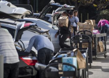 Amazon Flex drivers loading up their cars with packages.