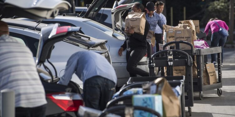 Amazon Flex drivers loading up their cars with packages.