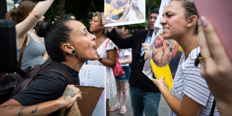 Pro- and anti-abortion demonstrators clash on Monday outside the Supreme Court.