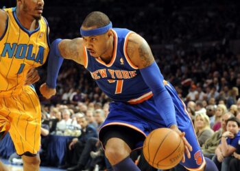 Knicks' Carmelo Anthony drives to the basket past Hornets Trevor Ariza during the first quarter of a game in 2011.