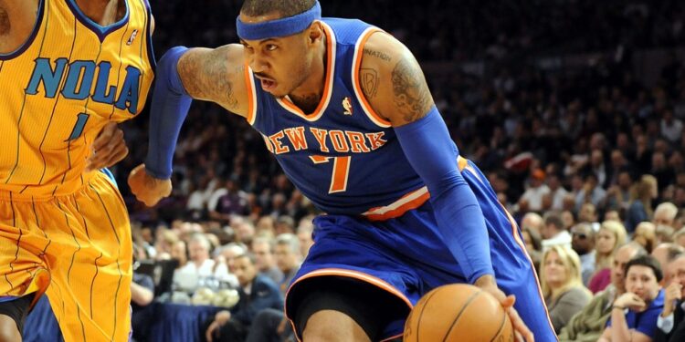 Knicks' Carmelo Anthony drives to the basket past Hornets Trevor Ariza during the first quarter of a game in 2011.