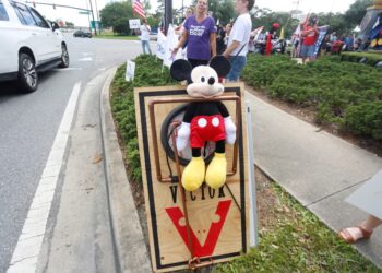 Supporters of Ron DeSantis' "Don't Say Gay" bill pin a Mickey Mouse doll to a mousetrap.