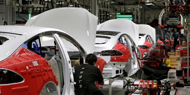 Cars move through the assembly line at Elon Musk's Tesla Motors at a factory in Fremont, Cali.