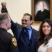 Actor Johnny Depp gestures to spectators in court after closing arguments at the Fairfax County Circuit Courthouse in Fairfax, Va., Friday, May 27,