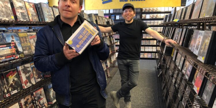 Local documentary filmmakers Taylor Morden, left, and Zeke Kamm, pose at the last Blockbuster on the planet in Bend, Ore., on Monday, March 11, 2019.