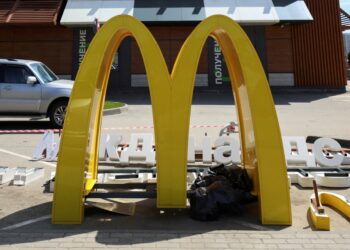 The 'M' in a McDonald's sign, sitting on the ground.