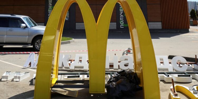 The 'M' in a McDonald's sign, sitting on the ground.