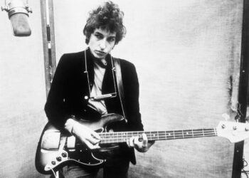 Bob Dylan posing with his guitar in 1966.