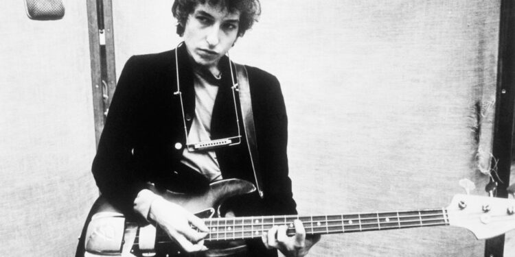 Bob Dylan posing with his guitar in 1966.