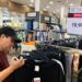 Customer checks price tags at clothing store.