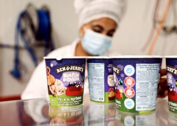 Tubs of ice-cream are seen as a labourer works at Ben & Jerry's factory in Be'er Tuvia, Israel