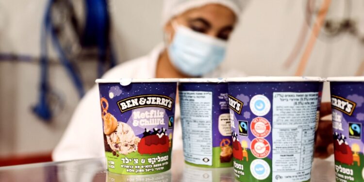 Tubs of ice-cream are seen as a labourer works at Ben & Jerry's factory in Be'er Tuvia, Israel