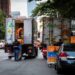 FreshDirect trucks block traffic on Columbus Avenue.