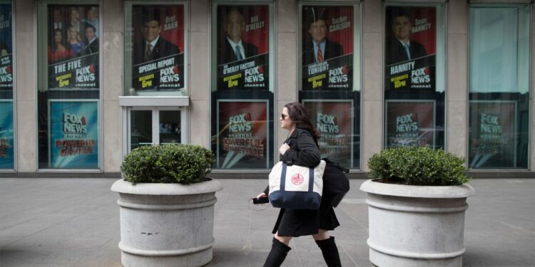 A woman walks past the News Corp. headquarters building in New York, April 19, 2017