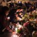 A woman sets down a candle in Rue Alibert, after terror attacks in Paris on Nov. 14, 2015.