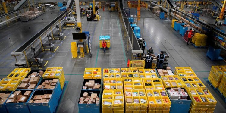 Workers select and pack items during Cyber Monday at the Amazon fulfilment center in Robbinsville Township, NJ.