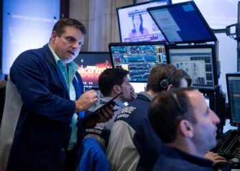 Traders work on the floor of the New York Stock Exchange