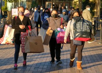 Shoppers carrying bags.