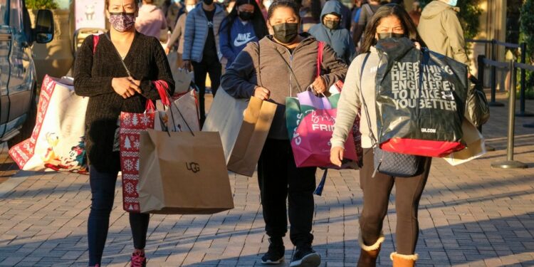 Shoppers carrying bags.