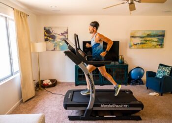 A man running on a NordicTrack machine.