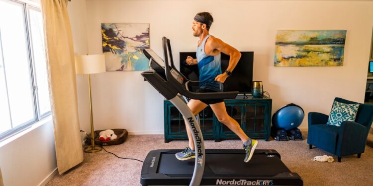 A man running on a NordicTrack machine.