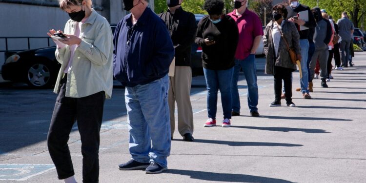 People line up outside a career center.