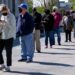 People line up outside a career center.
