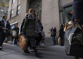 Shoppers carry bags.