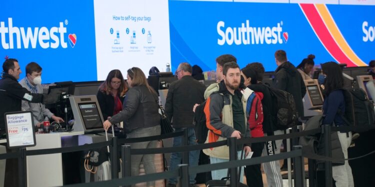 Travelers line up at the check-in counters for Southwest Airlines last week,