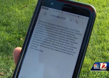 Photo of phone displaying layoff notice from UFI.