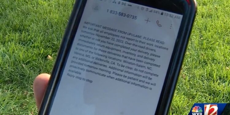 Photo of phone displaying layoff notice from UFI.
