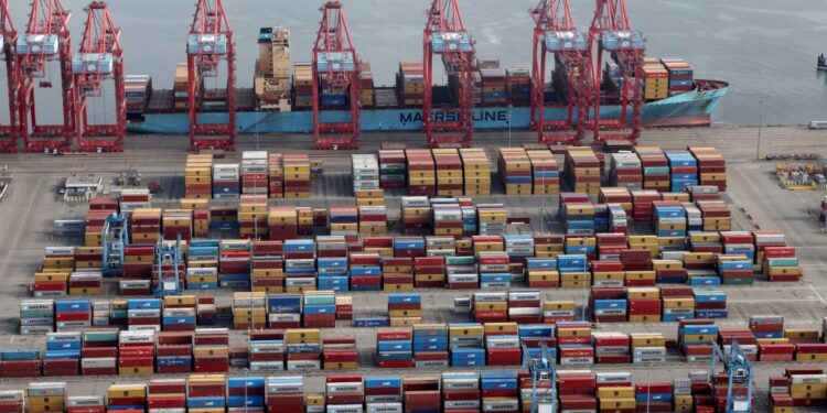 Shipping containers are unloaded he Port of Long Beach-Port of Los Angeles complex in 2021.