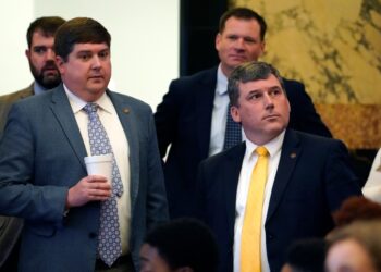Republican Sens. Jeremy England, R-Vancleave, left, and Daniel Sparks of Belmont, listen as the Senate Clerk tallies the vote on House Bill 401.