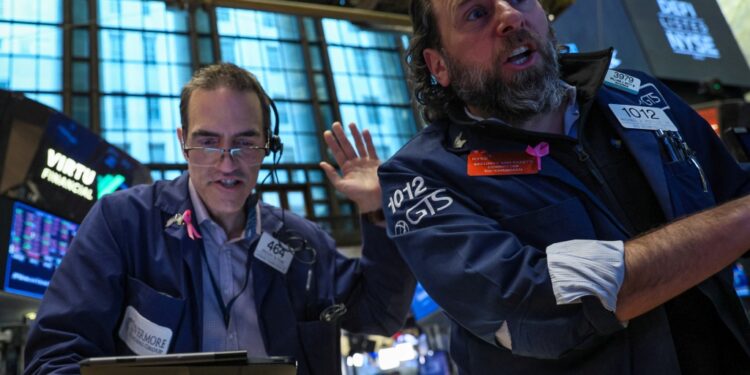 Traders work on the floor of the New York Stock Exchange Wednesday.