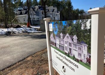 A sign announces newly built homes in Sudbury, Mass.