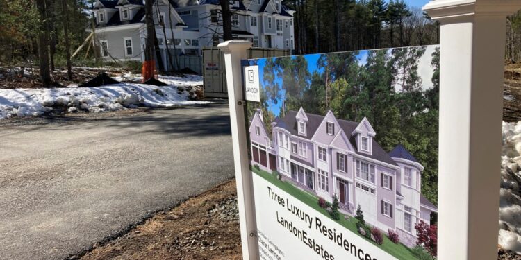 A sign announces newly built homes in Sudbury, Mass.