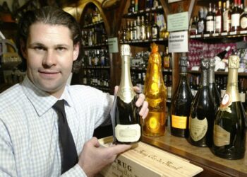 Shyda Gilmer displaying a bottle of champagne.