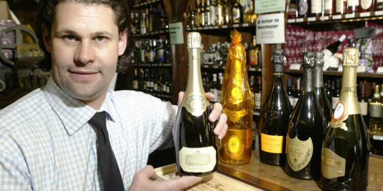 Shyda Gilmer displaying a bottle of champagne.