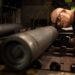 A steel worker inspects a 155 mm M795 artillery projectile during the manufacturing process at the Scranton Army Ammunition Plant in Scranton, Pa.