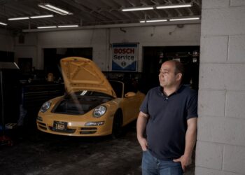 George Frem in his auto-repair shop