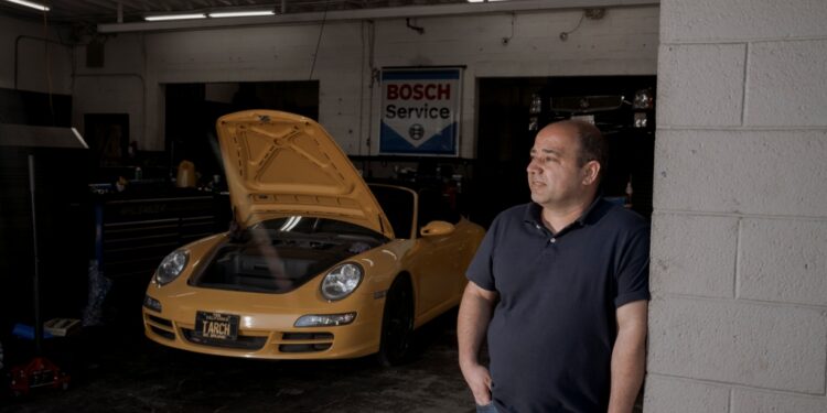George Frem in his auto-repair shop