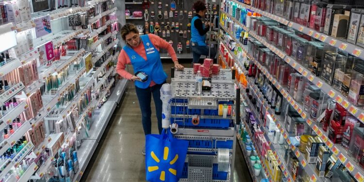 A Walmart employee organizes beauty products.