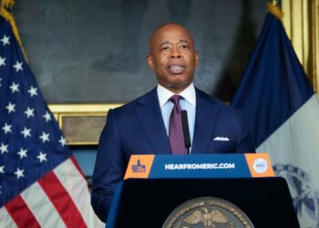Mayor Eric Adams handed out flyers for a city jobs fair at York College at an unannounced stop at the Jamaica, Queens Long Island Rail Road station on April 30, 2023.