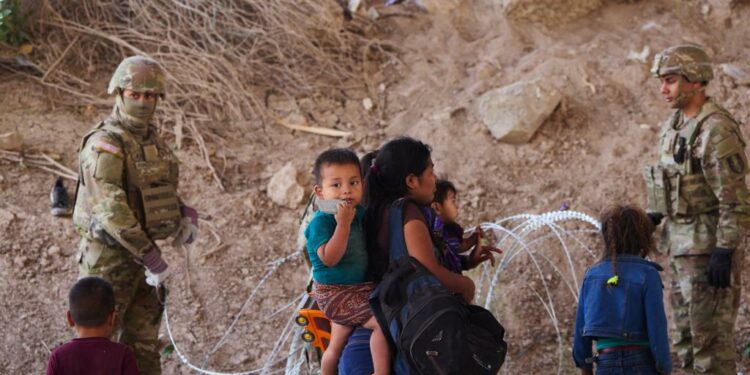 Migrants who crossed the U.S.-Mexico border  at the Rio Grande River are denied entry at the base of the Ysleta-Zaragoza bridge