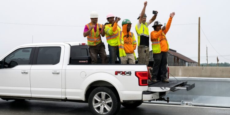 Employees with Buckley & Co. cheer as Interstate 95 is reopened