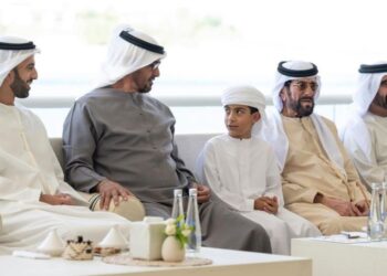 Members of the Abu Dhabi sit together on the couch.