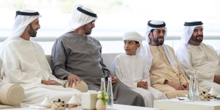 Members of the Abu Dhabi sit together on the couch.