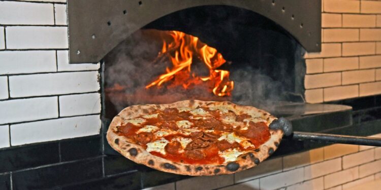 A hot pizza, fresh out of the wood fired oven at Fornino Pizzeria in Greenpoint.
