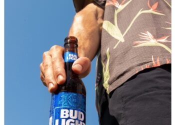 The tweet that was posted on Saturday features an image of a man holding an open bottle of Bud Light.