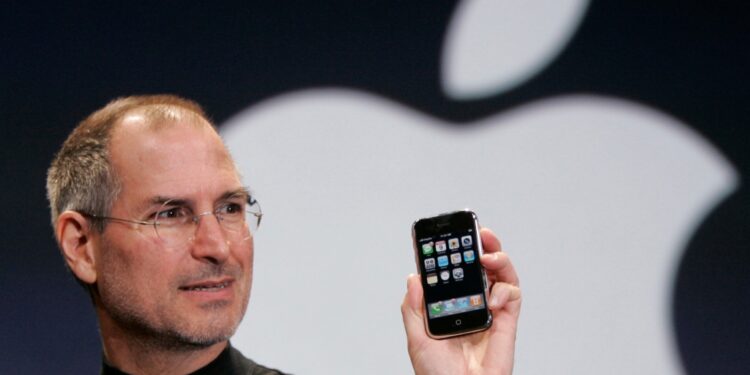Apple CEO Steve Jobs holds up an iPhone in 2007.